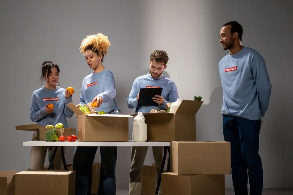 Volunteers packing boxes of food donations for community distribution